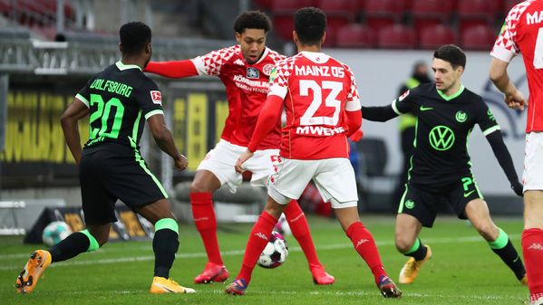 Die VfL Wolfsburg Spieler Ridle Baku und Josip Brekalo im Duell um den Ball mit zwei Spielern von Mainz 05.